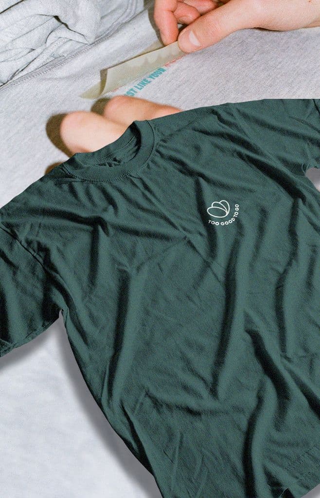 a green t-shirt that says too good on it