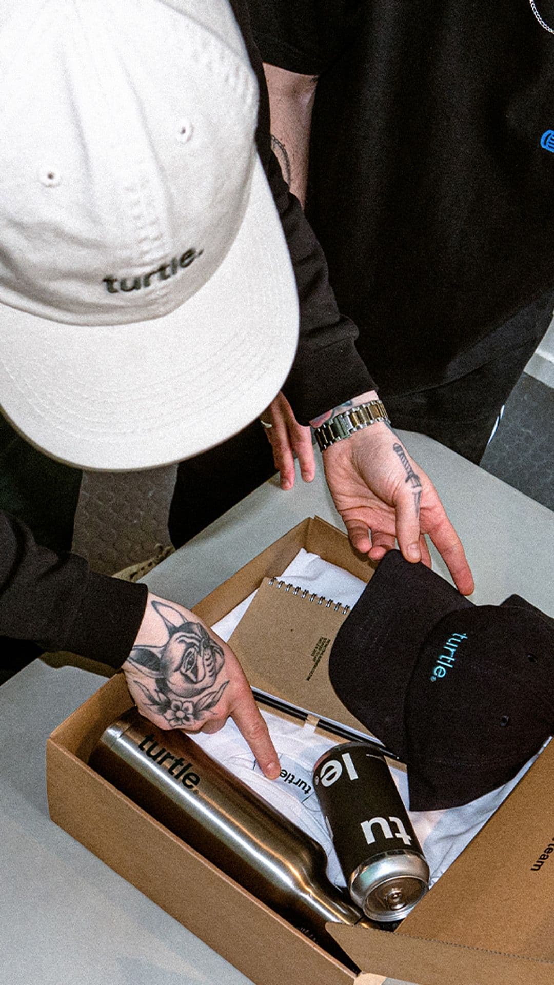 a man wearing a hat with the word turtle on it