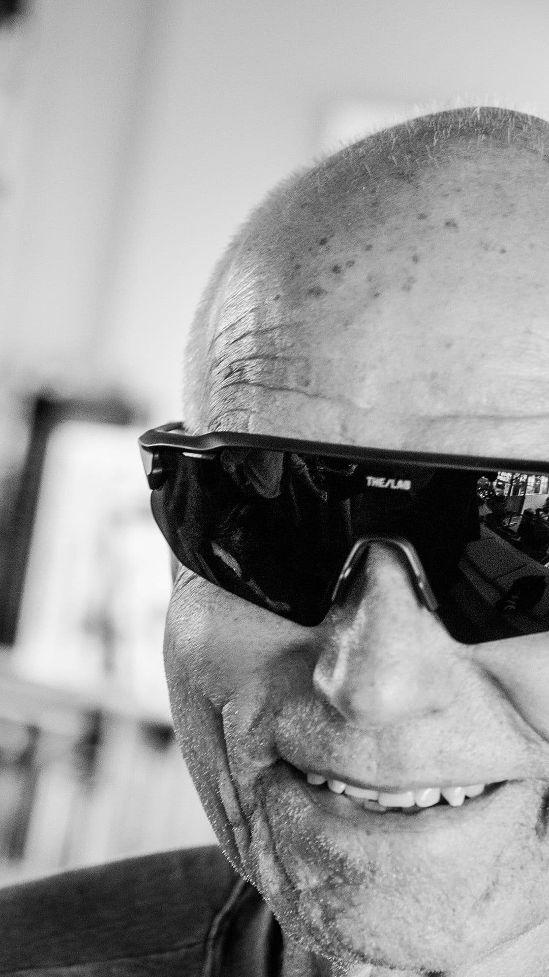 a man wearing a pair of sunglasses with the letters THE LAB