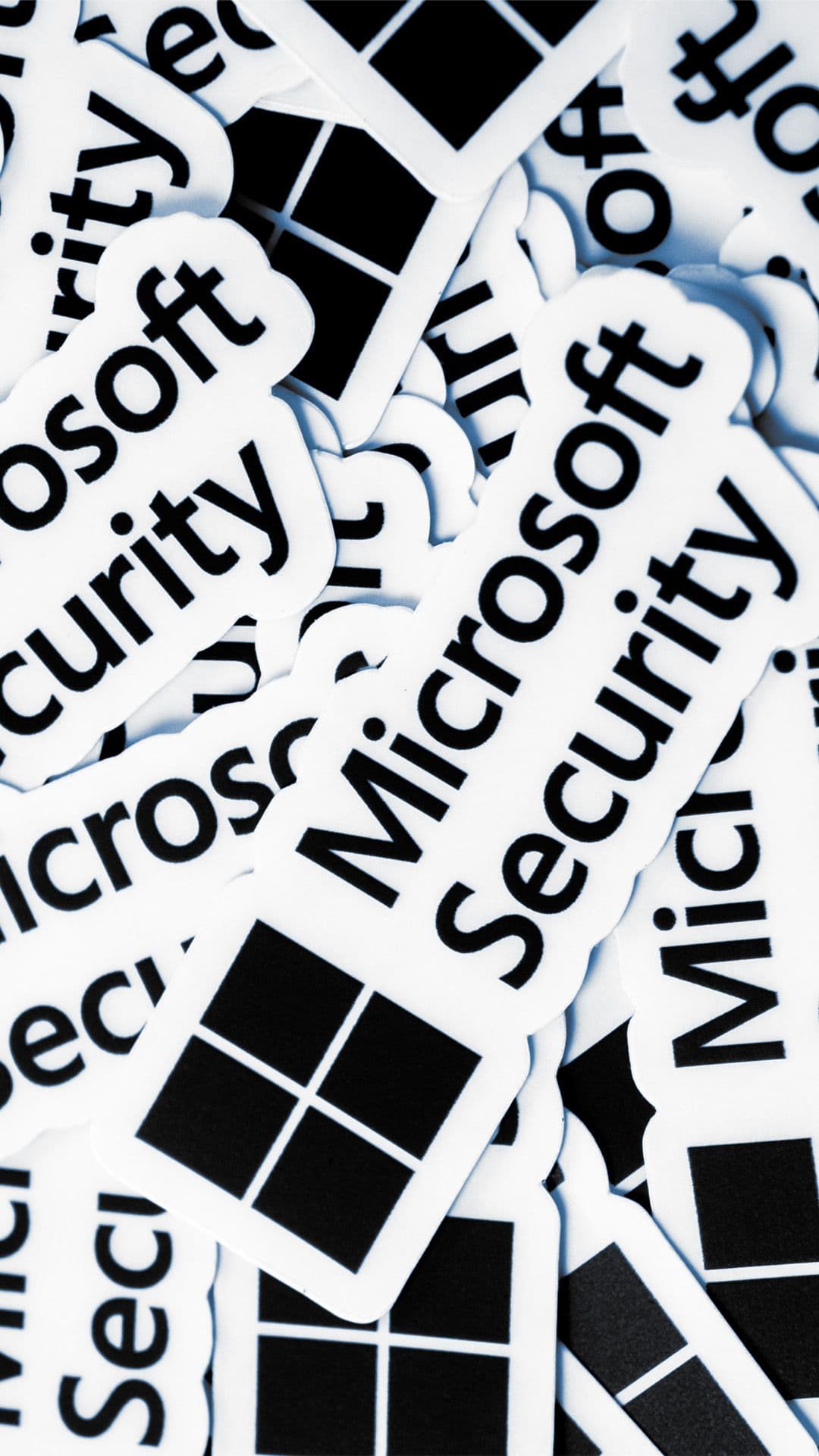 a pile of microsoft security stickers on a white surface